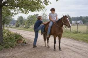 An adult steadies a child seated on a horse along a rural lane.